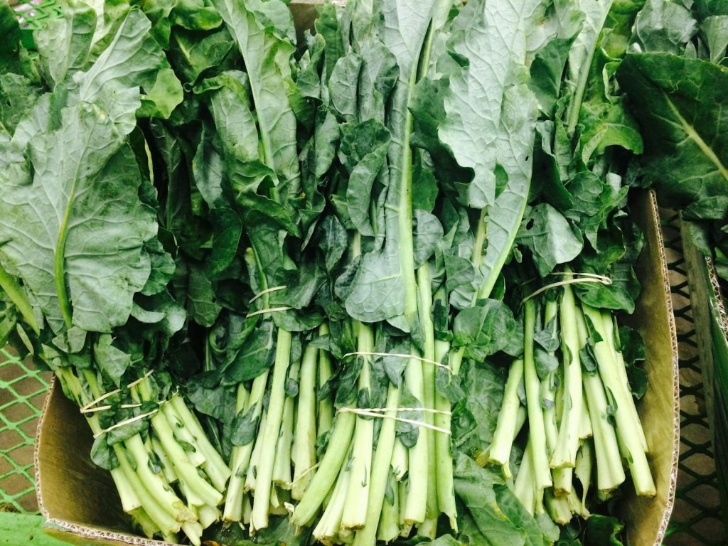 Vibrant fresh green leafy vegetables on display, showcasing organic produce.