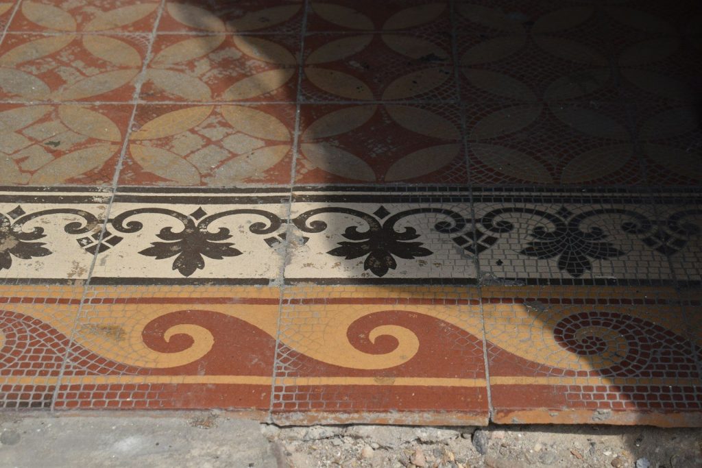Ornate tiled floor with geometric and wave patterns.