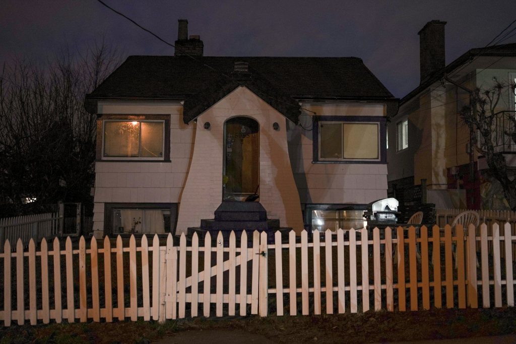 a white picket fence in front of a house