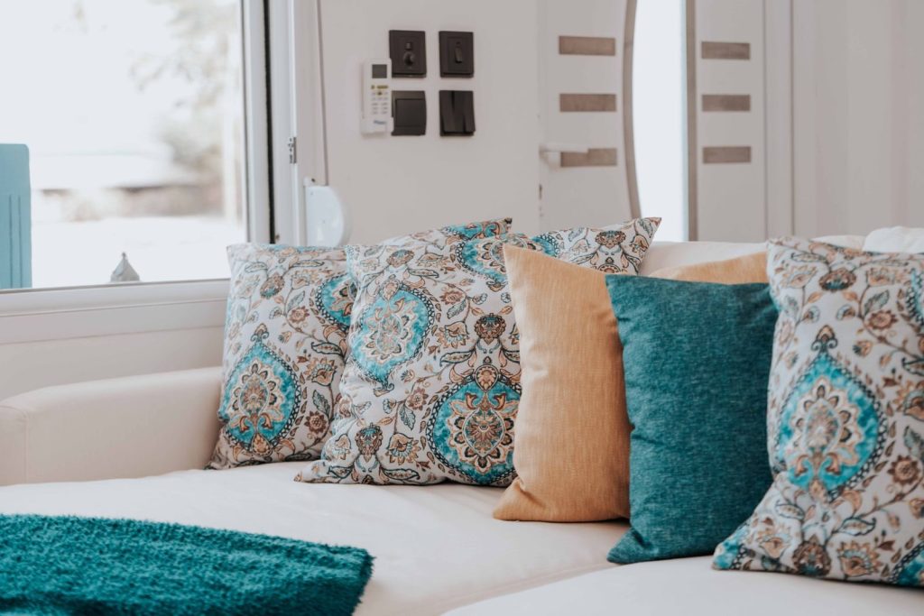Cozy modern sofa with patterned and solid throw pillows for a chic living room look.