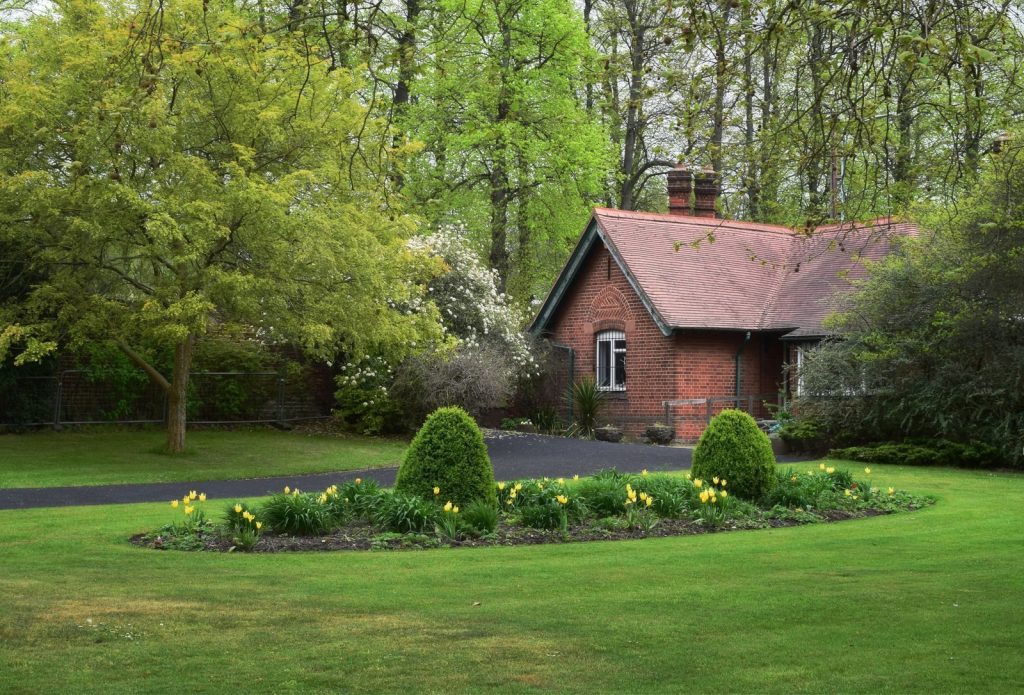 Picturesque brick cottage surrounded by a green garden in Dartford, UK.