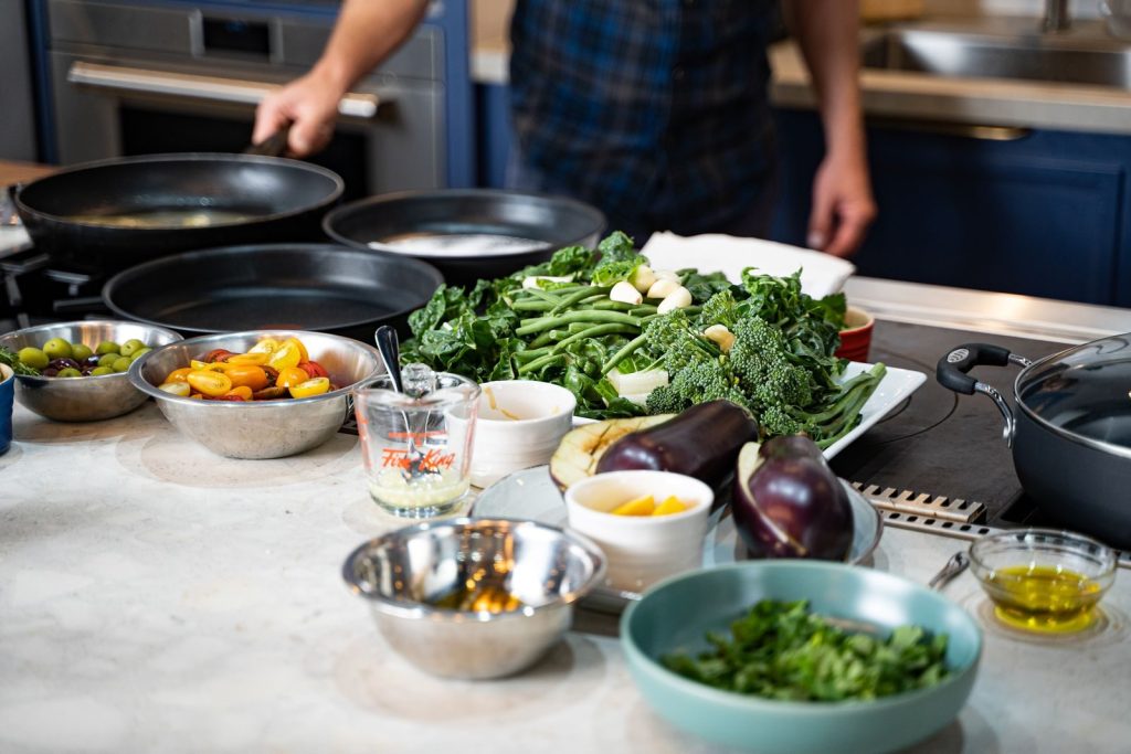 Fresh vegetables ready for cooking in a modern kitchen setting with natural light.