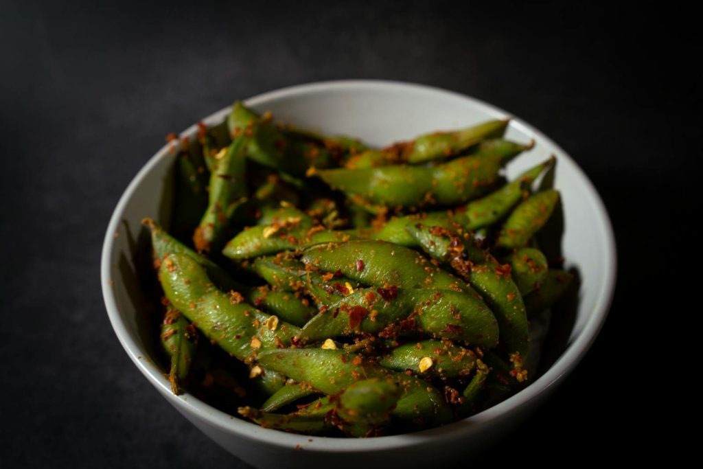 Close-up of spicy edamame beans in a bowl, showcasing vibrant flavors and textures.