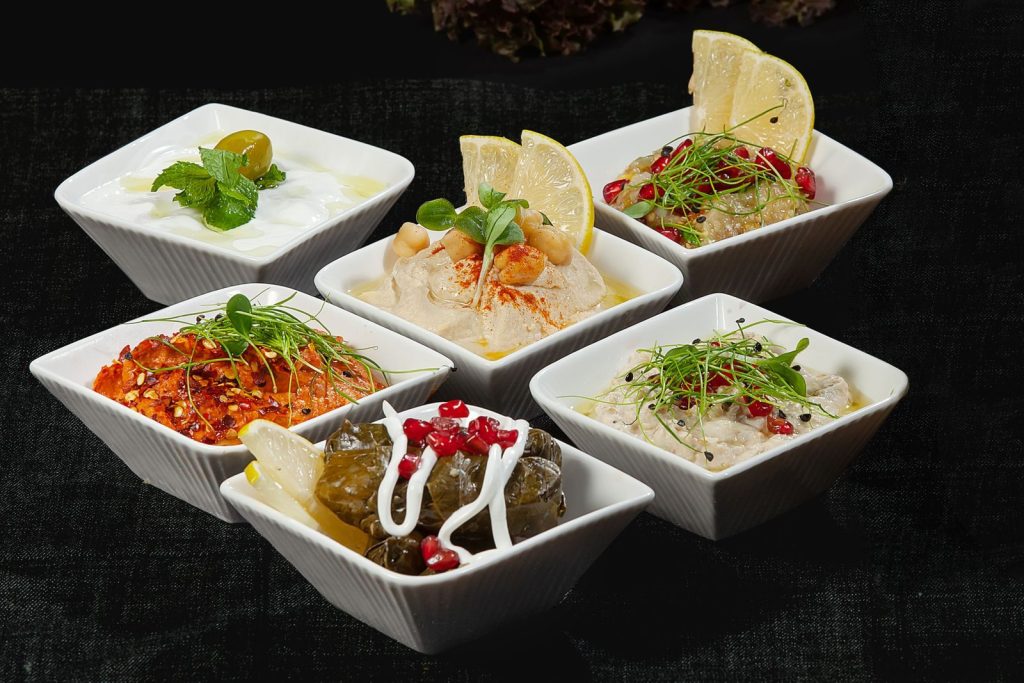A selection of delicious Mediterranean appetizers served in stylish ceramic bowls.