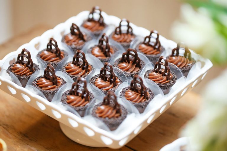 Close-up of beautifully frosted chocolate cupcakes on a white tray, perfect for dessert indulgence.