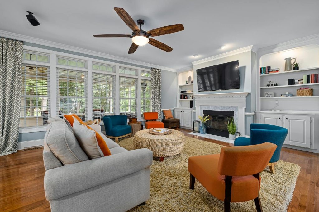 Stylish modern living room featuring a fireplace, television, and contemporary furniture.