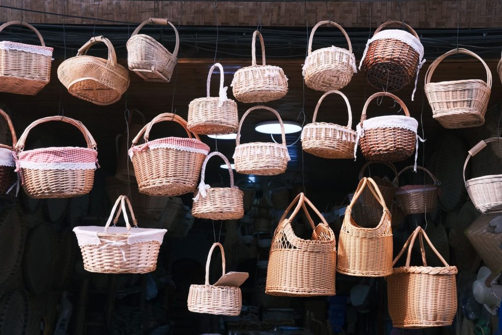 A selection of wicker baskets hanging indoors, showcasing different styles and textures.