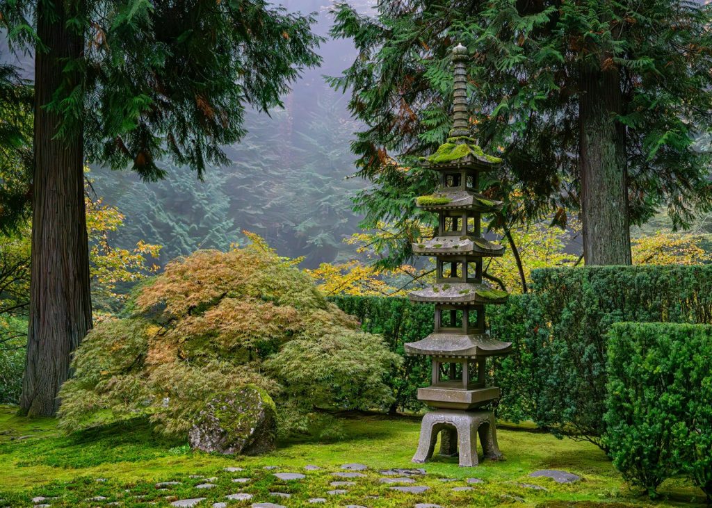 A garden with a stone bench in the middle of it