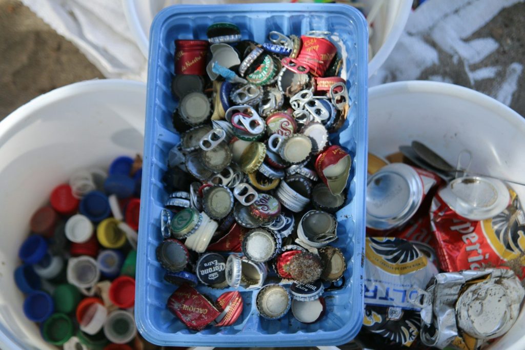 Trash is sorted into buckets and trays.