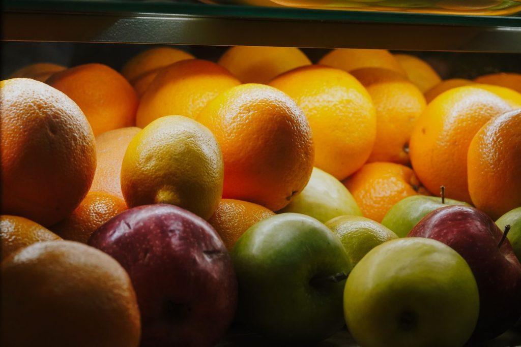 A colorful display of fresh oranges, red and green apples in natural light. Perfect for healthy lifestyle visuals.