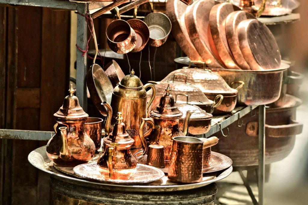 Stunning array of traditional copper kitchenware showcased at a vibrant market.