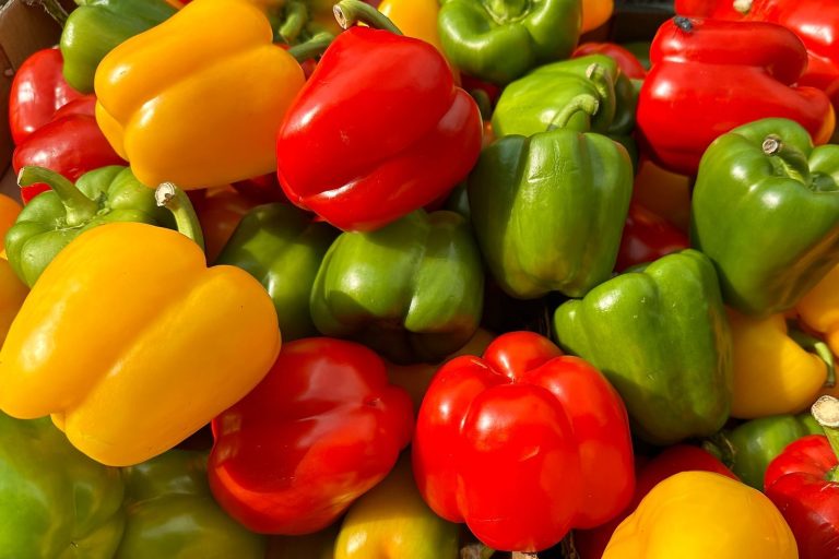 Close-up view of colorful bell peppers showcasing freshness and vibrant texture, perfect for food photography.