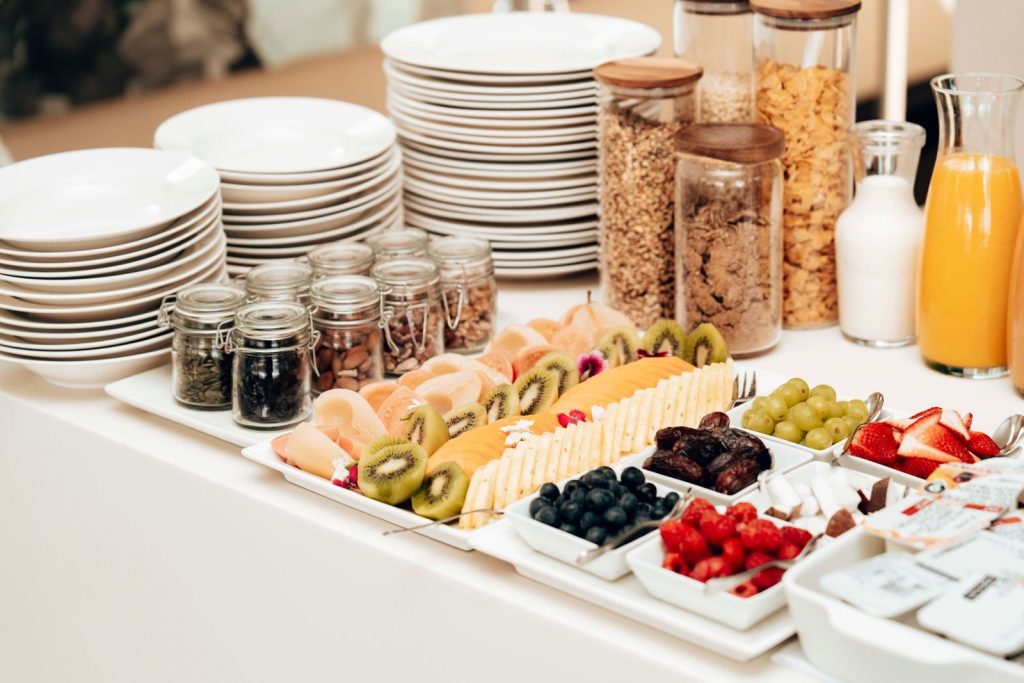 A colorful and nutritious continental breakfast buffet featuring fresh fruits, cereals, and juices.