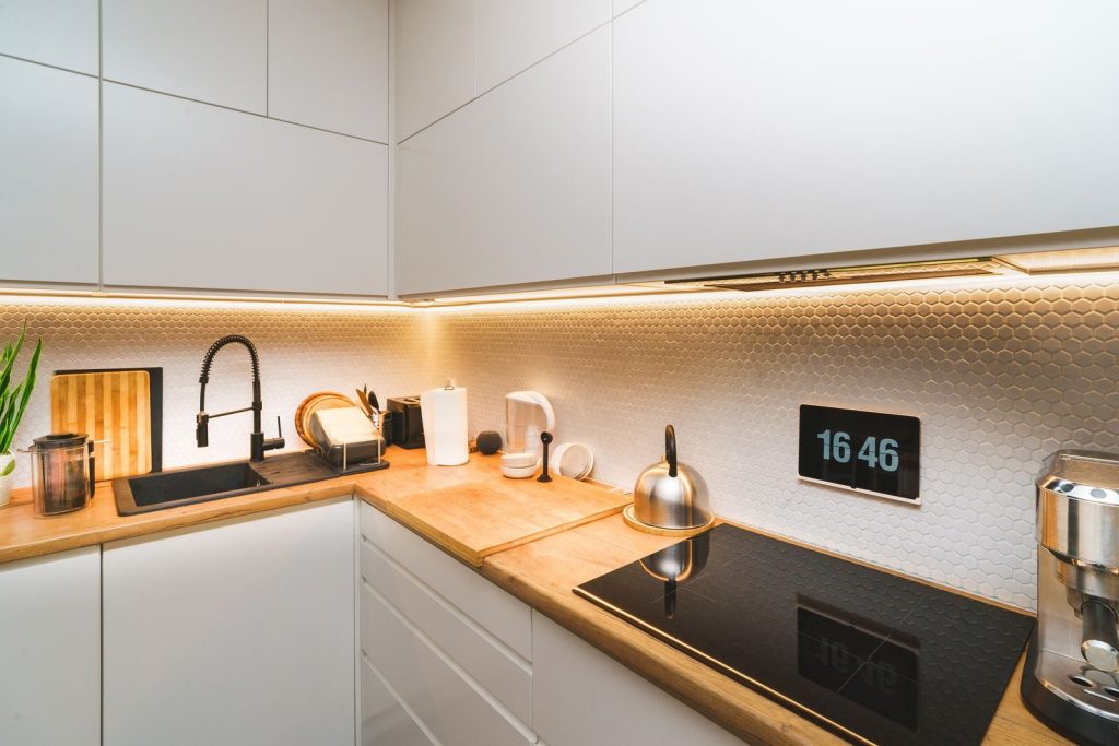 A modern kitchen featuring minimalist design with sleek countertops and advanced appliances.