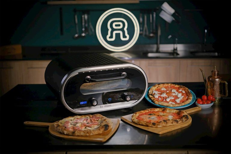 A couple of pizzas sitting on top of a counter