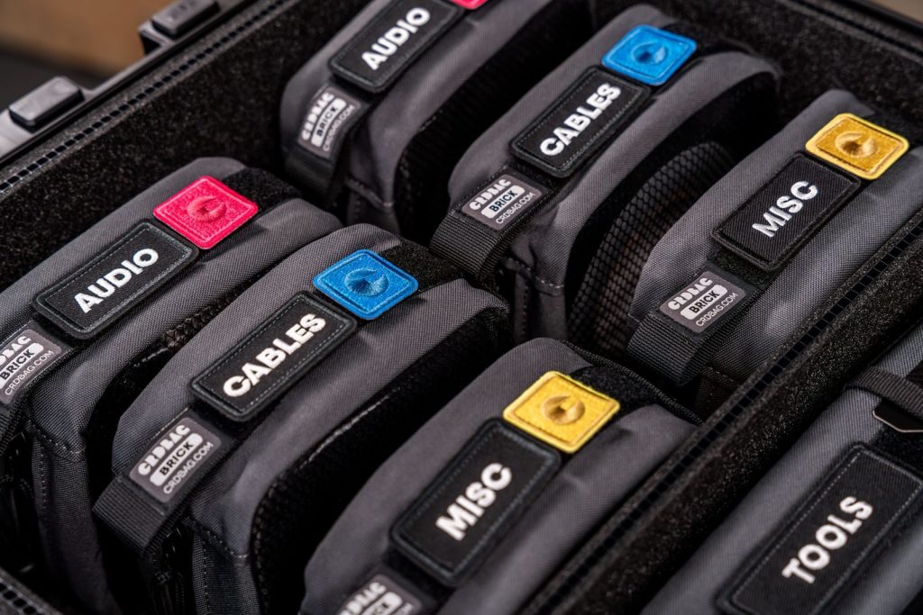Close-up of labeled equipment bags in a protective case, showcasing organization and utility.