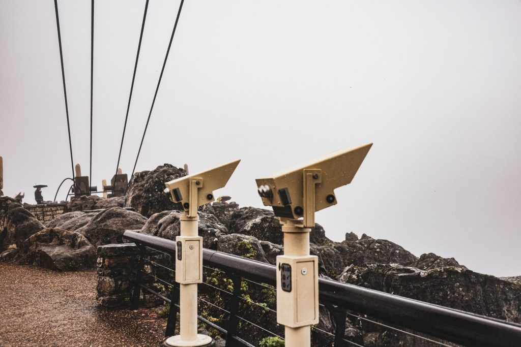 Telescopes overlooking a misty viewpoint on Table Mountain, South Africa.