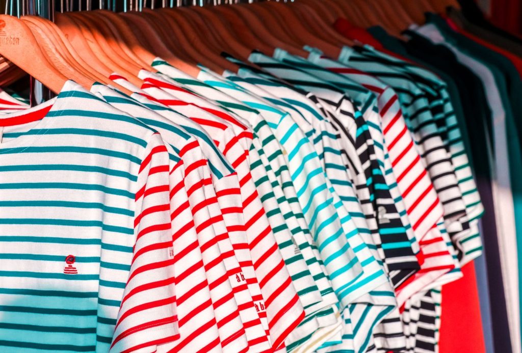 Colorful striped shirts hanging in a store in Arzon, Bretagne, France