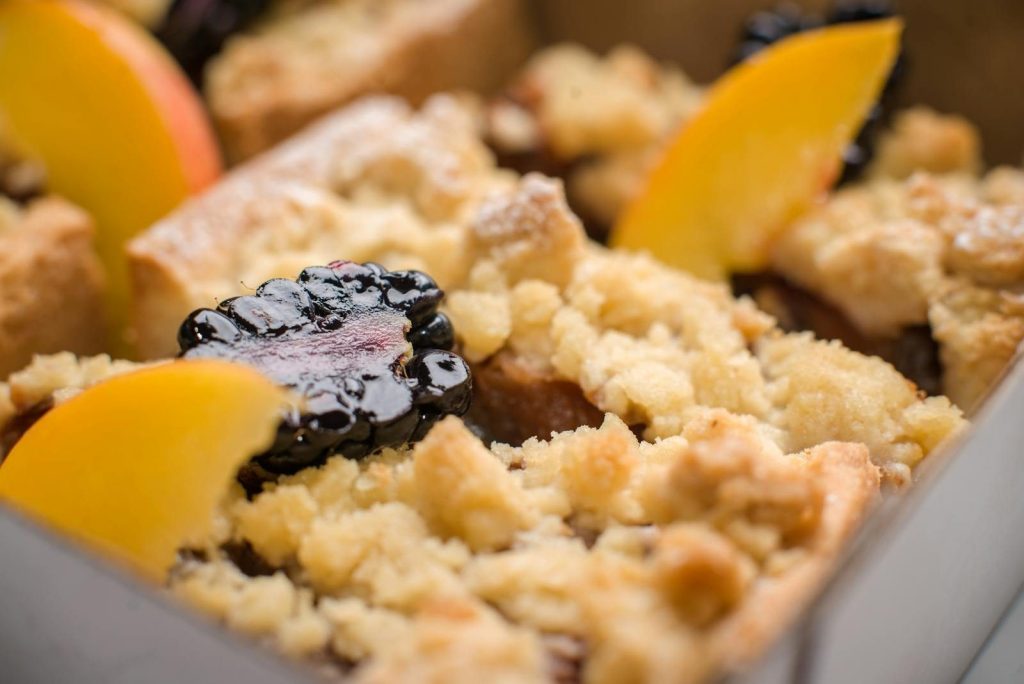 Delicious close-up of blackberry peach crumble with golden crust.