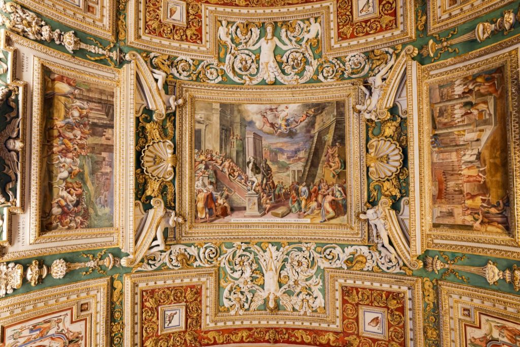 Elegant painted ceiling showcasing classical Roman art and architecture.