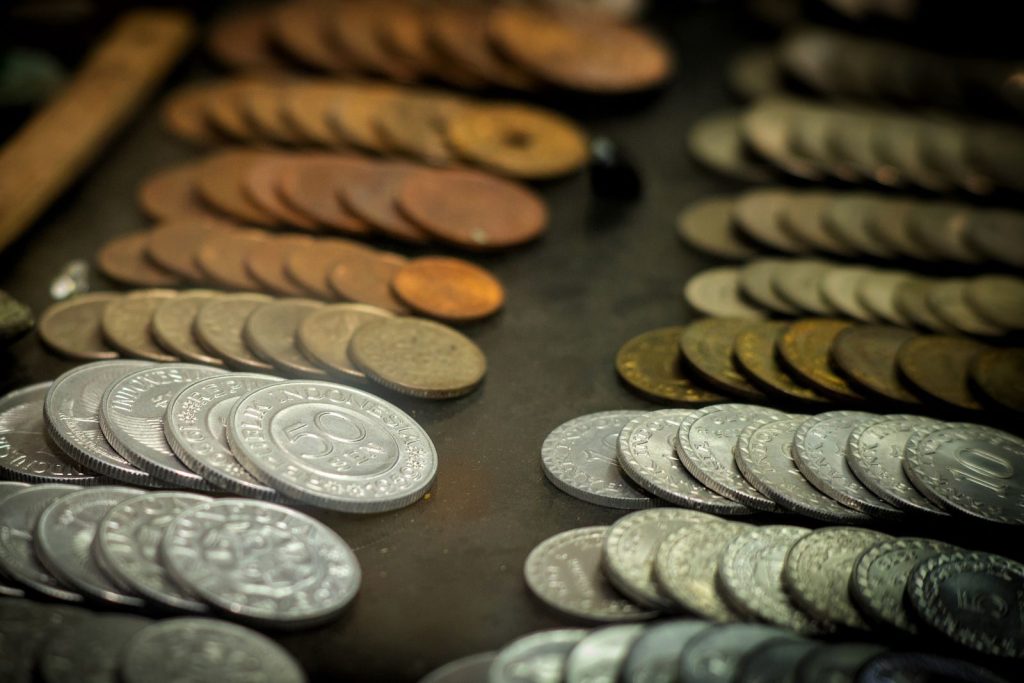 A close-up shot of vintage Indonesian coins displayed on a surface, highlighting various denominations and materials.