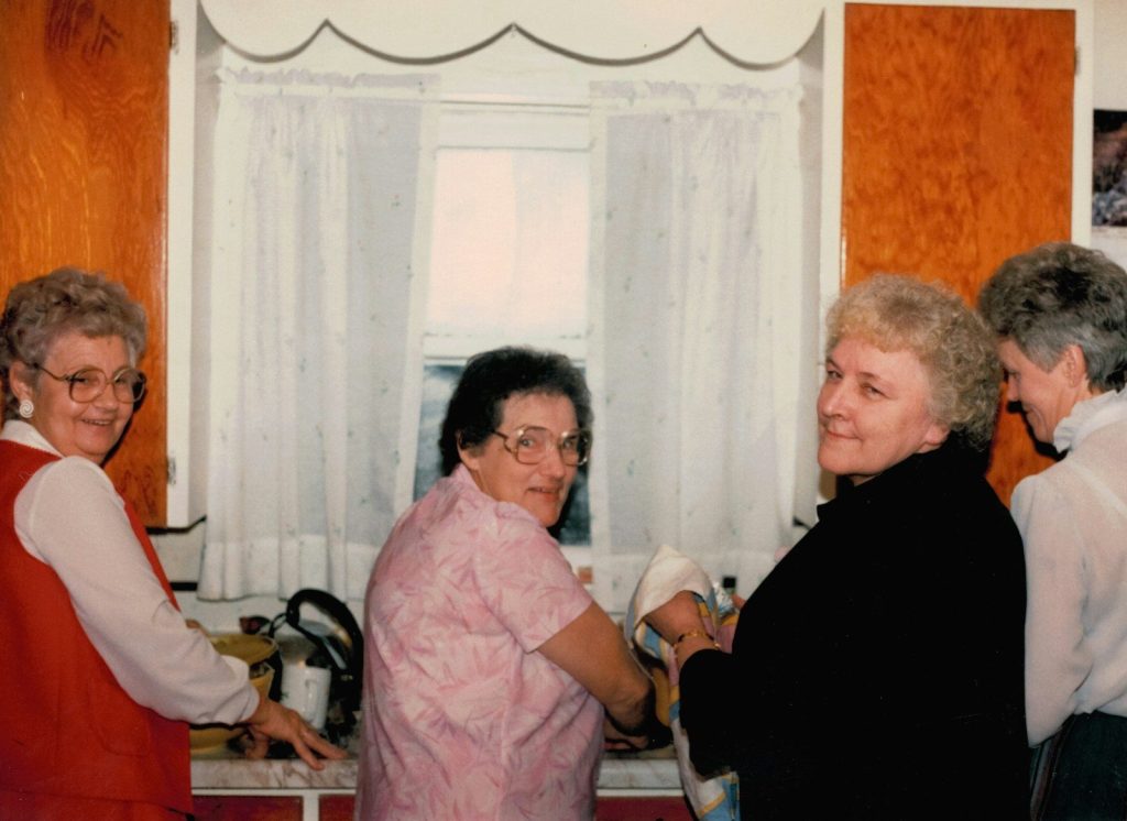 Four women gathered in a kitchen