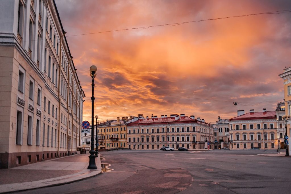 Majestic sunset over urban cityscape with historic buildings and empty streets.
