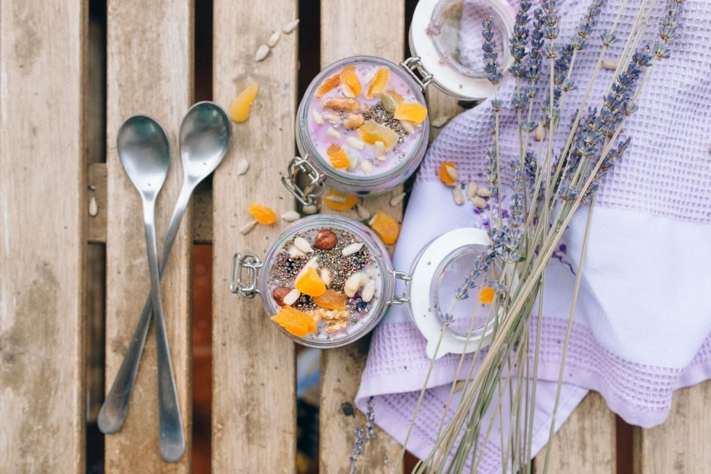 Top view of tasty chia pudding topped with fruits and lavender, perfect for food photography.