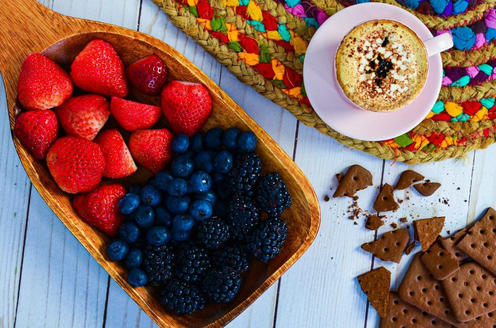 a bowl of strawberries, raspberries, blueberries, strawberries,