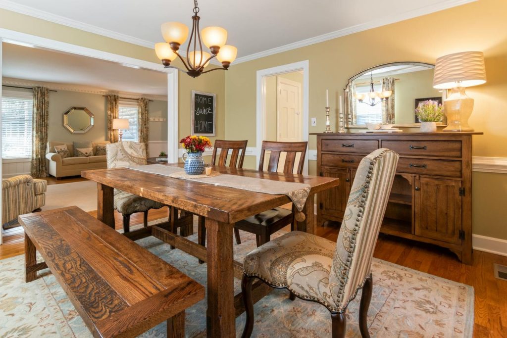 Warm dining room interior featuring rustic wooden furniture and classic decor elements.
