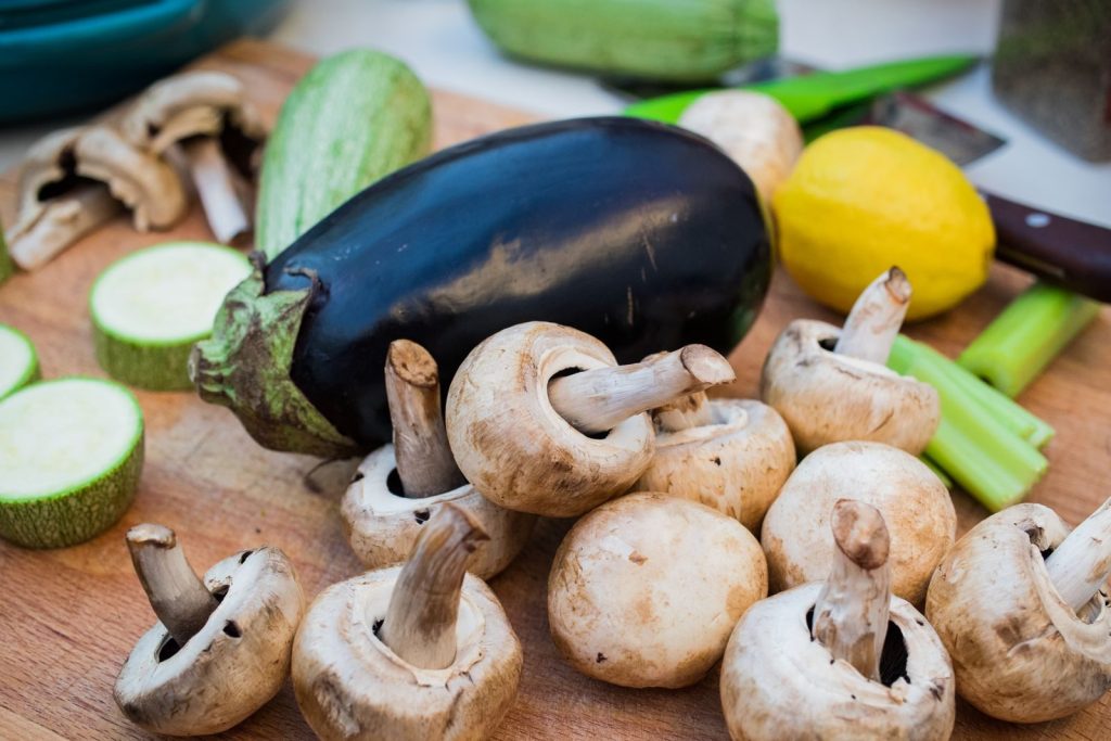 Close-up of fresh vegetables on a wooden board, perfect for food photography.
