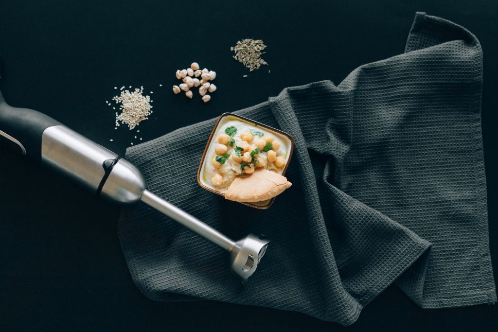 Delicious Mediterranean hummus with chickpeas and pita, styled in a modern flat lay.