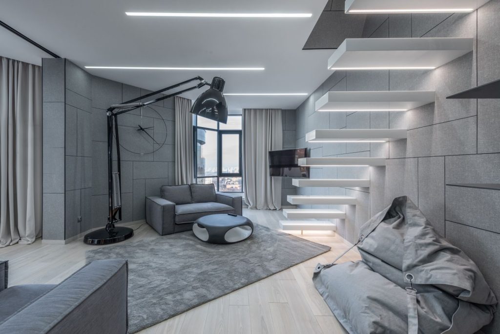 Interior of contemporary room with stylish furniture in minimalistic style in modern apartment in daylight