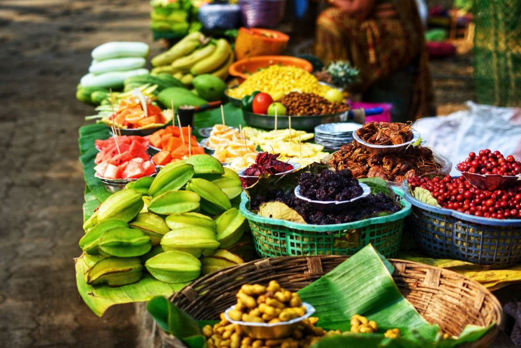 Colorful assortment of fresh fruits displayed for sale at a market stall.
