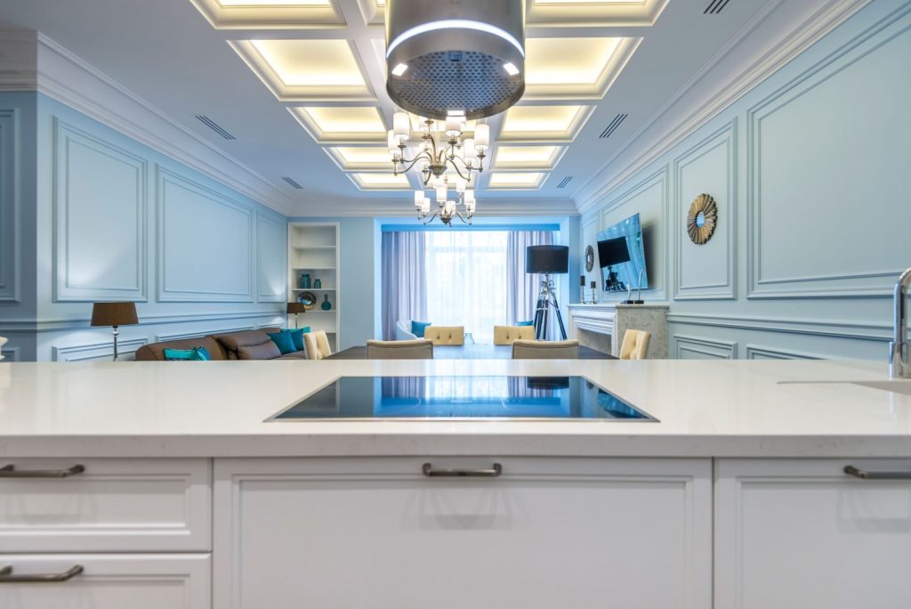 A luxurious living room showcasing elegant interior design with a chandelier and modern decor.