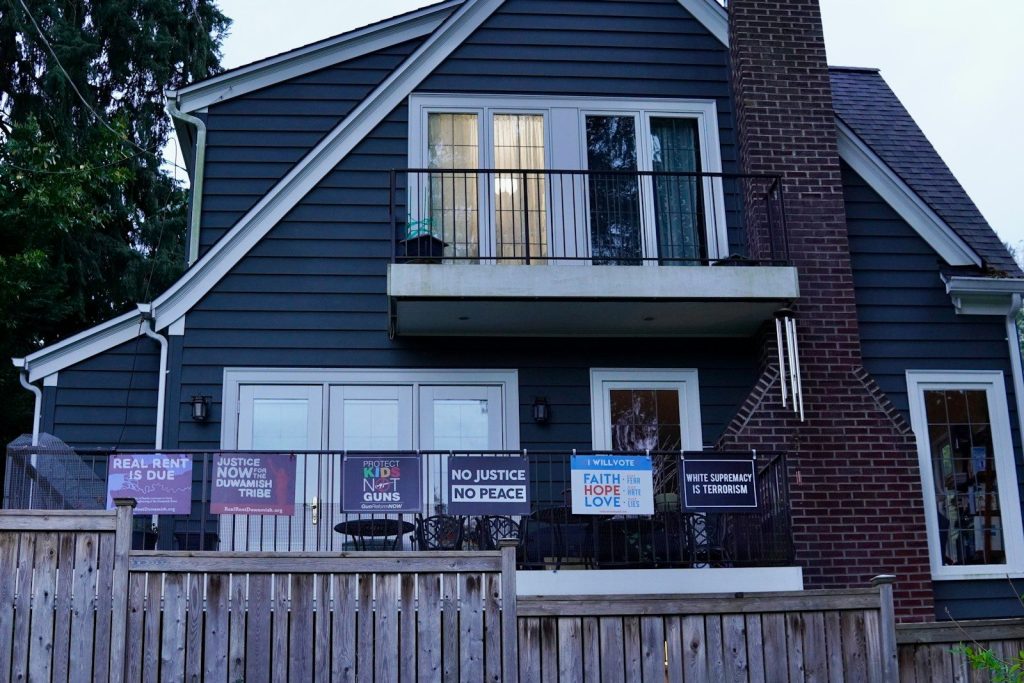 a blue house with signs on the front of it
