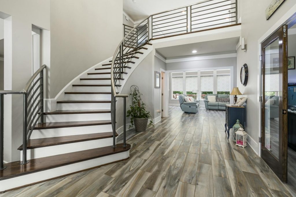 Spacious modern home interior featuring a curved staircase and stylish decor.