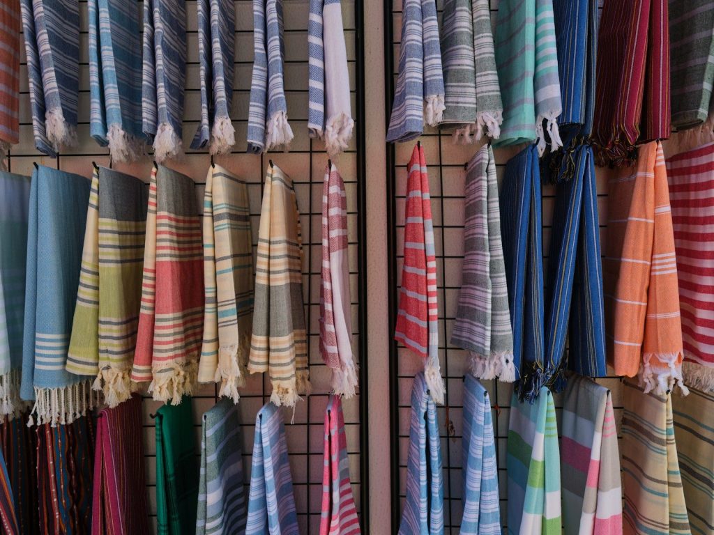 a bunch of towels hanging up on a rack