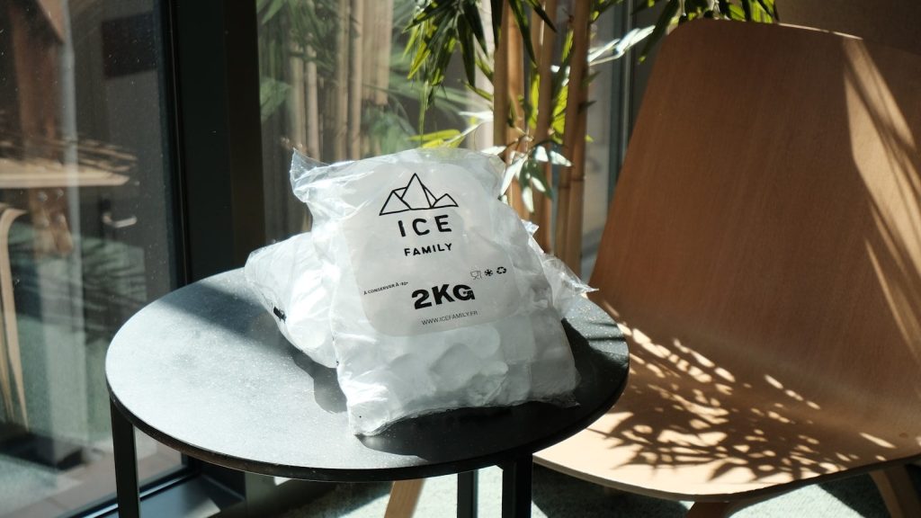 Two bags of ice on a round table.