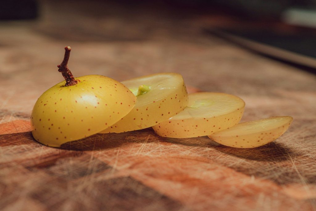yellow fruit on brown wooden table