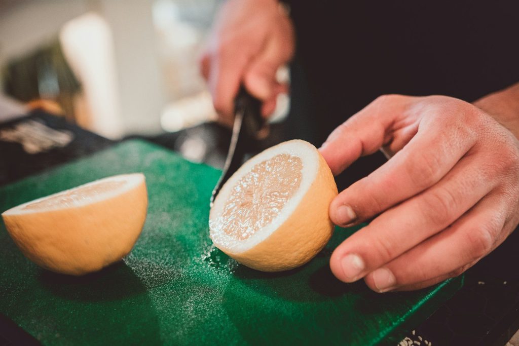 a person cutting a fruit