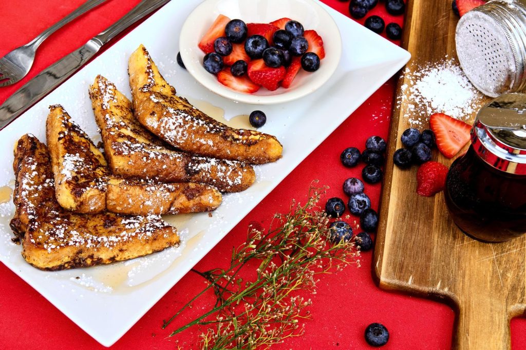 Enjoy a delicious breakfast with French toast and fresh berries, perfect for a cozy morning meal.