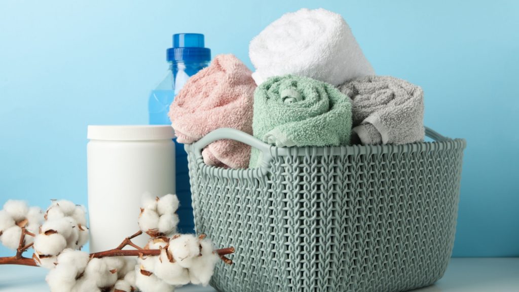 Laundry accessories on white table against blue background
