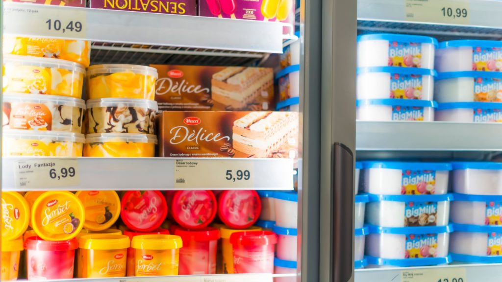 Bangsar, Malaysia – Mar 29, 2025: Top view of various branded ice cream tubs neatly arranged in a supermarket freezer, including Cremeria, Walls, Magnolia, and Nestle.