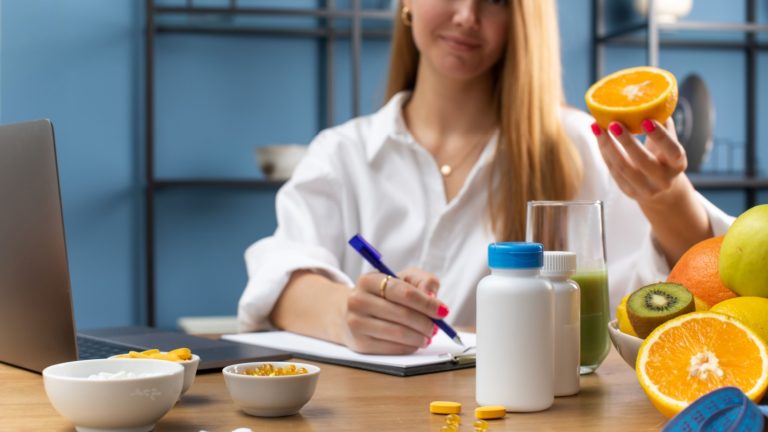 A nutritionist doctor prescribes vitamins at his desk, in the foreground are mockups of nutritional supplements