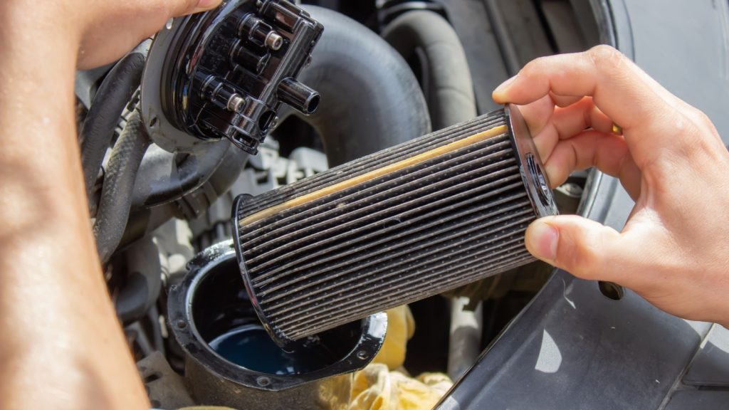 Technician changes car filter, car spare part. Car service concept. selective focus