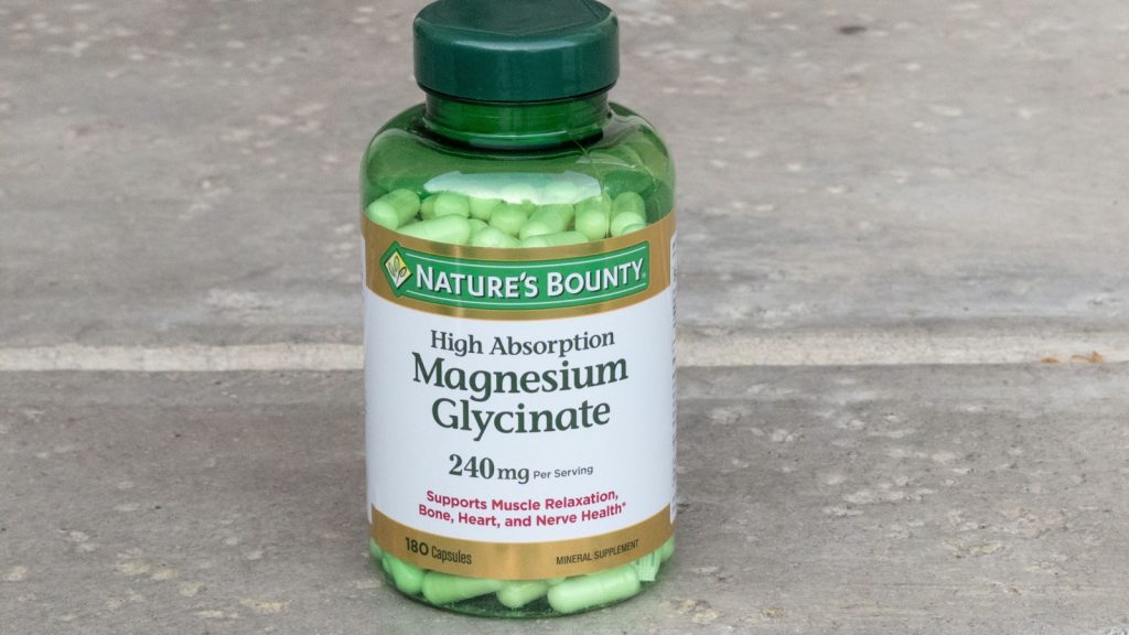 Los Angeles, CA - July 11, 2025: Nature's Bounty Magnesium Glycinate Supplement Bottle on Concrete.