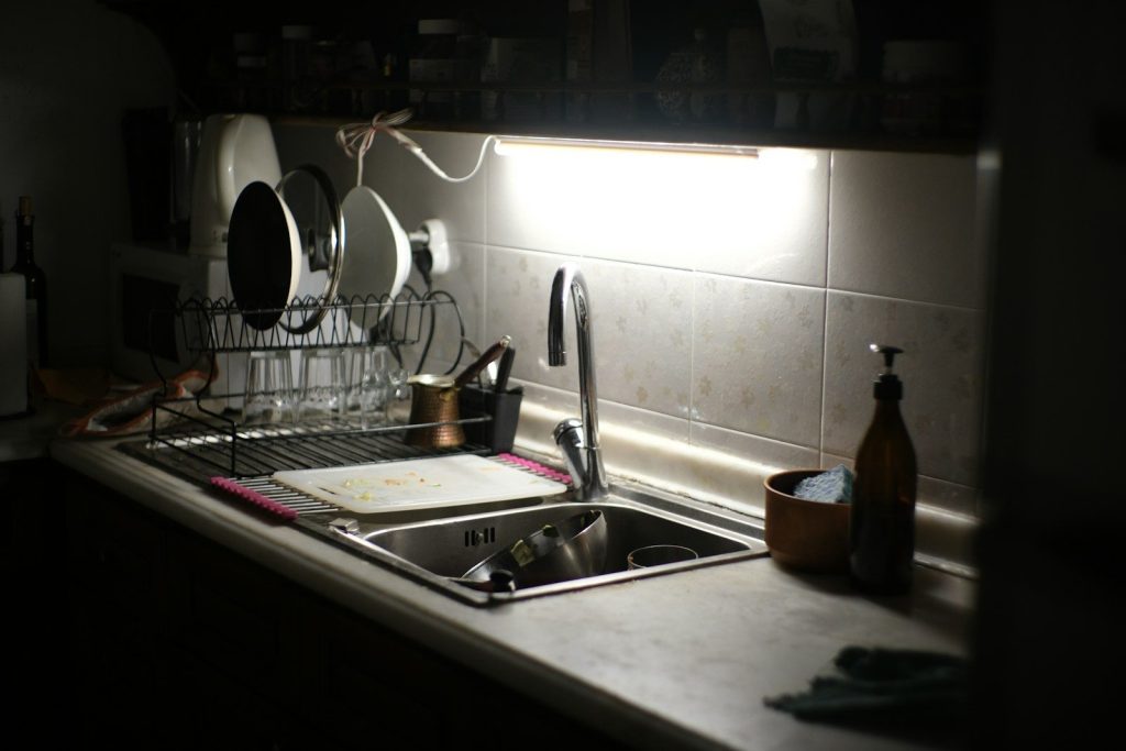 A kitchen sink with dishes drying