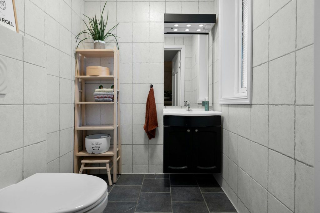 A white toilet sitting next to a white sink
