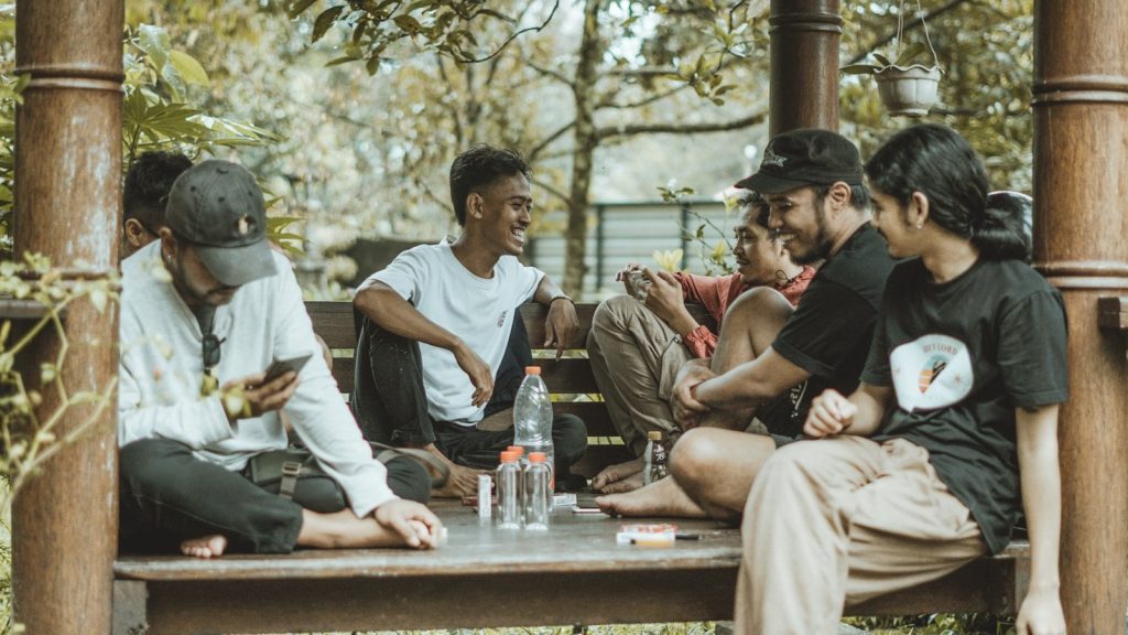 Friends are relaxing and chatting together outdoors.
